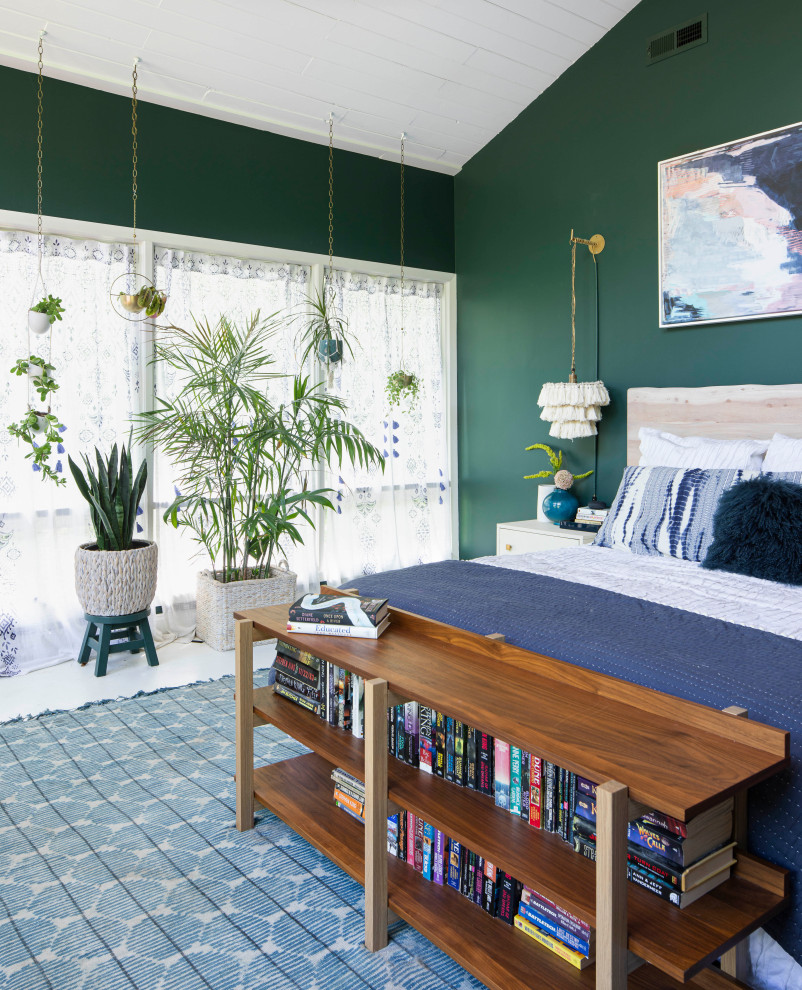 Modelo de dormitorio principal campestre grande sin chimenea con paredes verdes, suelo de madera clara y suelo blanco