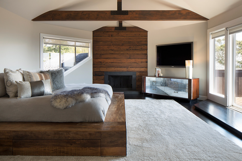 Contemporary master bedroom in San Francisco with beige walls, a standard fireplace and a wooden fireplace surround.