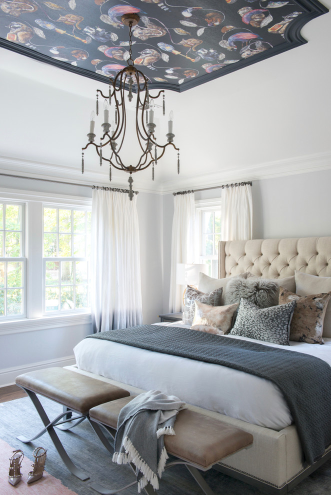 Inspiration for a large transitional master medium tone wood floor bedroom remodel in New York with gray walls
