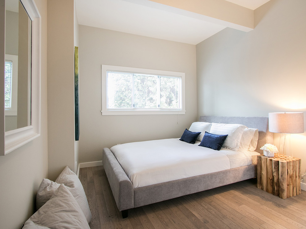 Small eclectic guest bedroom in Vancouver with grey walls and light hardwood flooring.