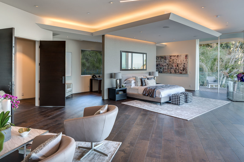 This is an example of a medium sized modern master bedroom in Los Angeles with white walls, dark hardwood flooring and feature lighting.