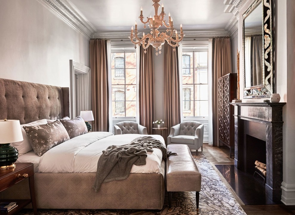 This is an example of a medium sized classic master bedroom in Philadelphia with beige walls, a standard fireplace, medium hardwood flooring, brown floors and feature lighting.