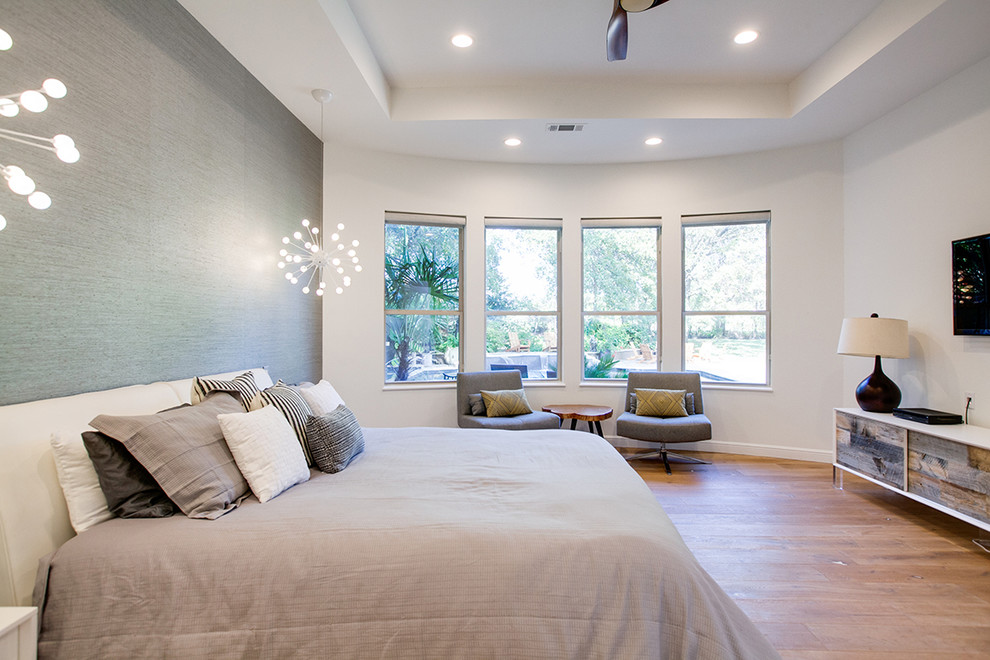 Example of a large trendy master light wood floor bedroom design in Dallas with white walls and no fireplace