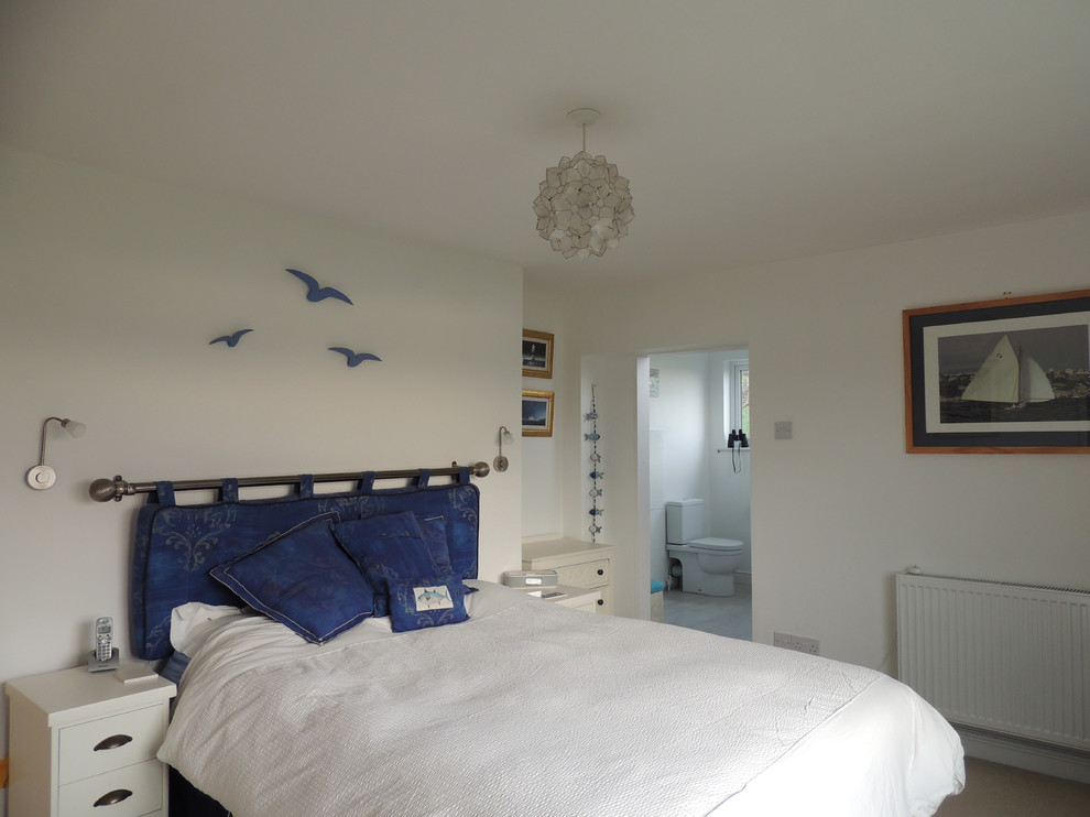 Small coastal bedroom in Devon with white walls.