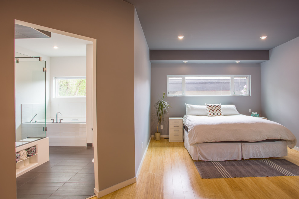Свежая идея для дизайна: хозяйская спальня среднего размера в современном стиле с серыми стенами и полом из бамбука без камина - отличное фото интерьера