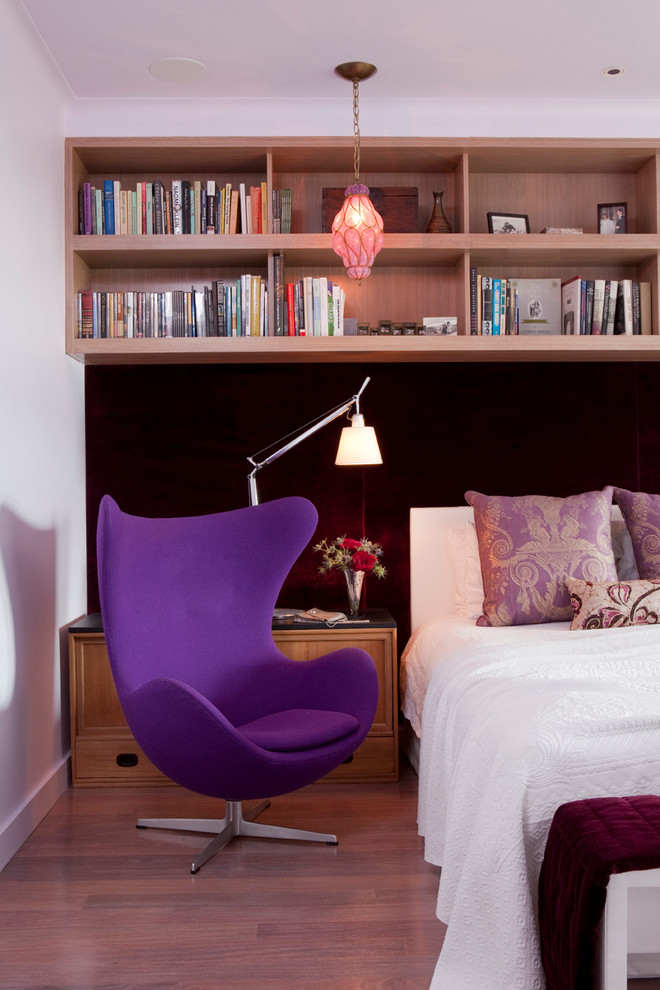 Example of a trendy light wood floor bedroom design in New York with white walls