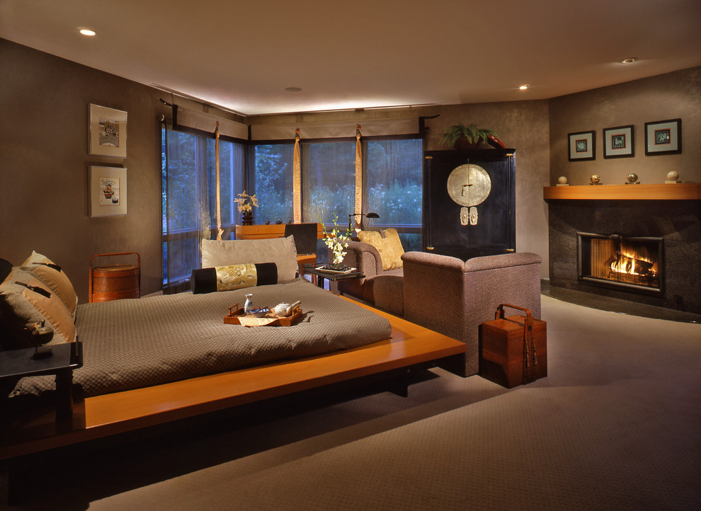 Large zen master carpeted bedroom photo in Chicago with brown walls, a standard fireplace and a stone fireplace