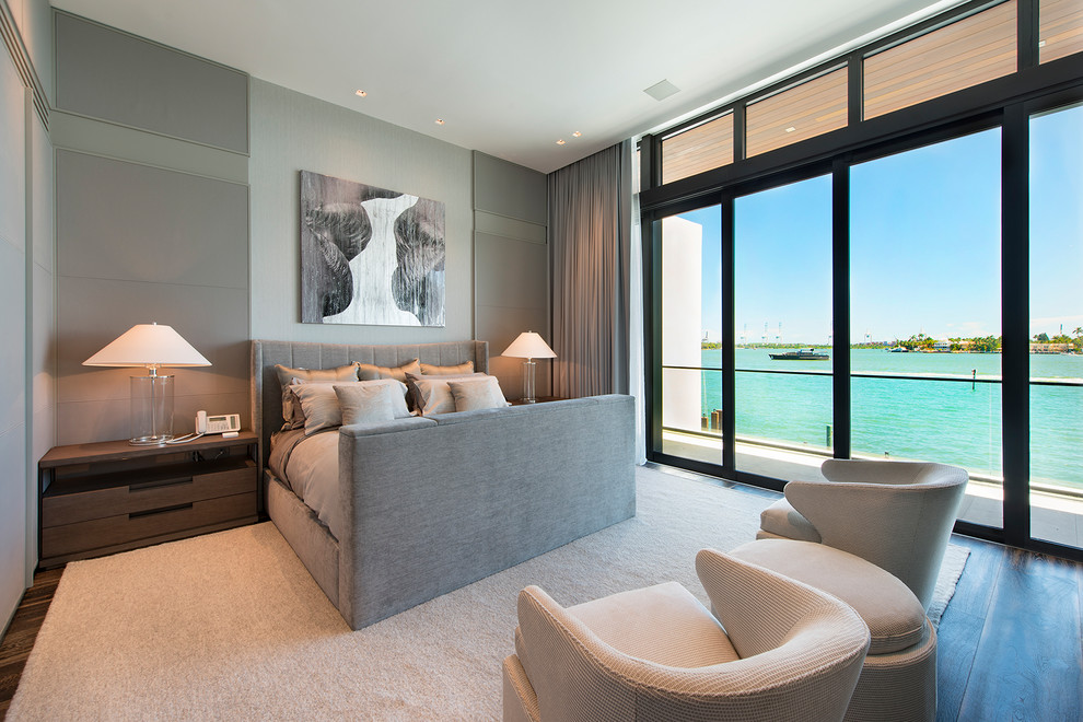 This is an example of an expansive contemporary grey and brown bedroom in Miami with grey walls, dark hardwood flooring and brown floors.