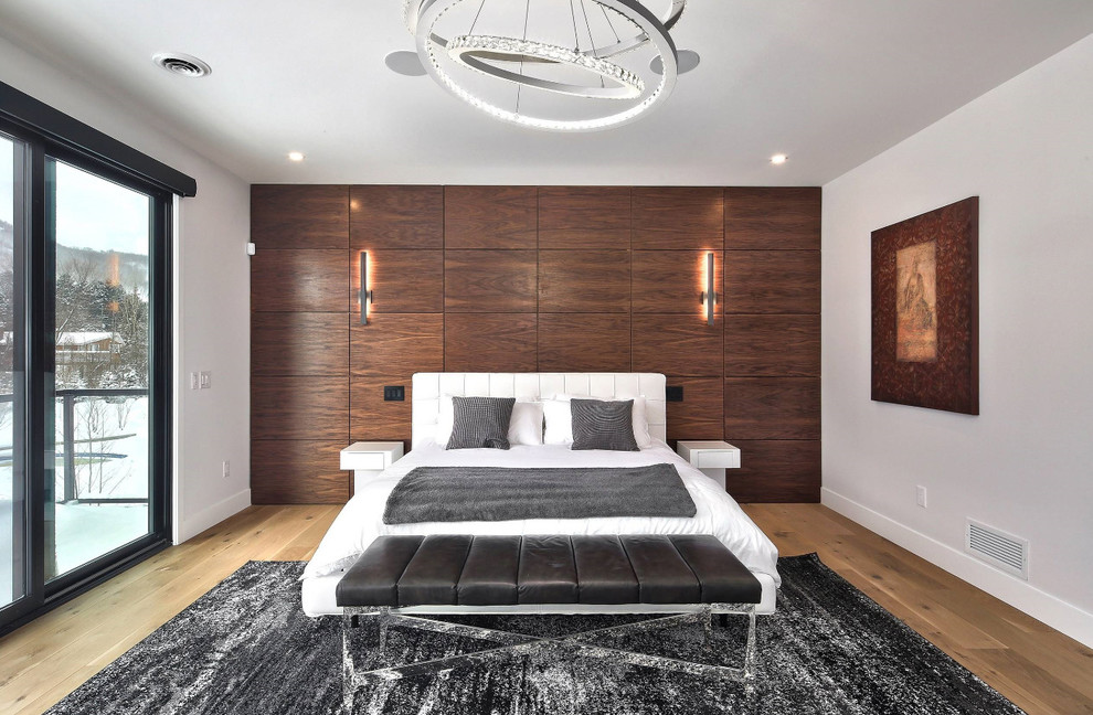 Diseño de dormitorio principal contemporáneo grande con paredes grises, suelo de madera en tonos medios y suelo marrón