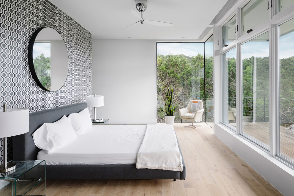 Contemporary bedroom in Austin with multi-coloured walls, light hardwood flooring and beige floors.