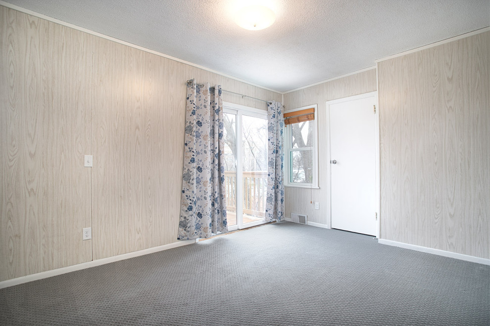 Photo of a small retro master bedroom in Minneapolis with beige walls, carpet, grey floors and wallpapered walls.