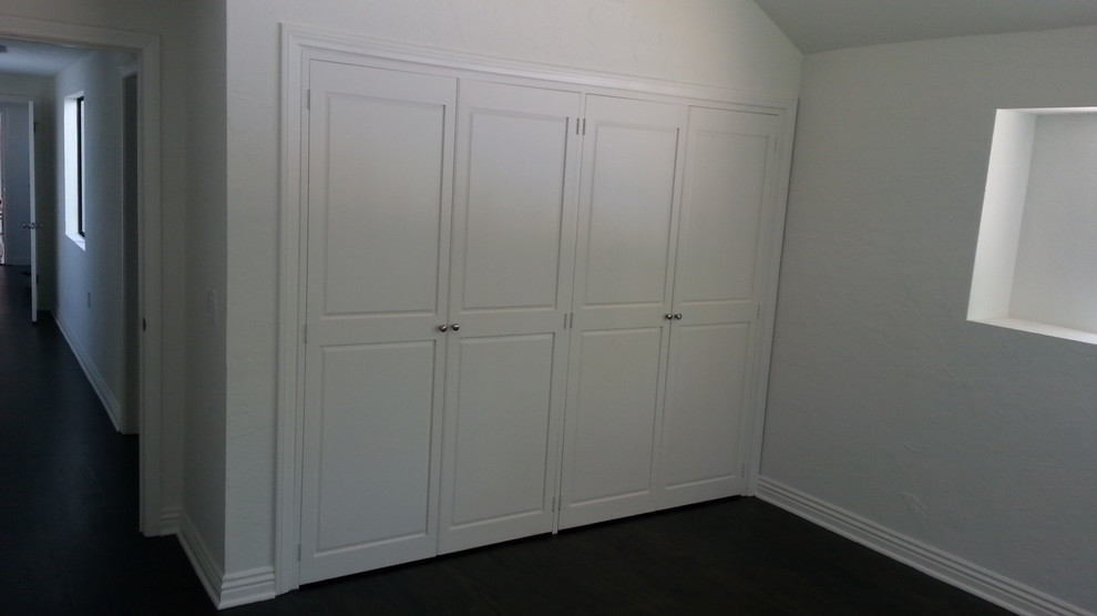 Mittelgroßes Klassisches Gästezimmer mit weißer Wandfarbe und dunklem Holzboden in Los Angeles