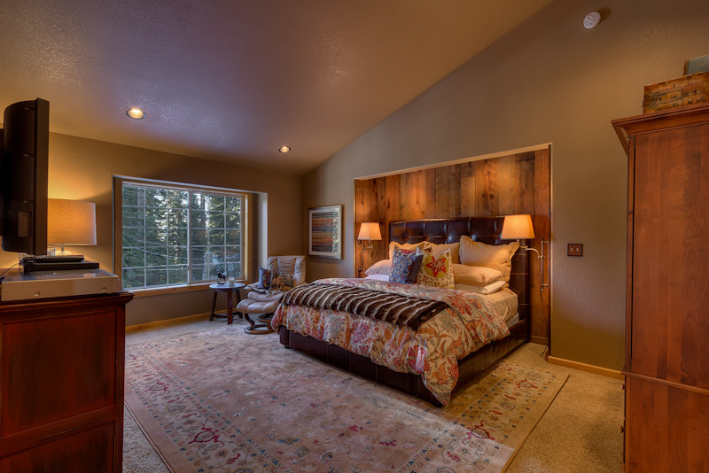 Photo of a rustic bedroom in Sacramento with beige walls and carpet.