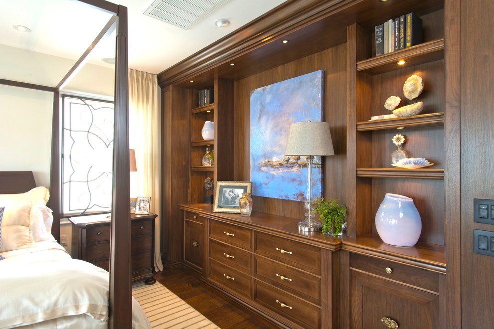 This is an example of a large classic master bedroom in San Diego with beige walls and dark hardwood flooring.