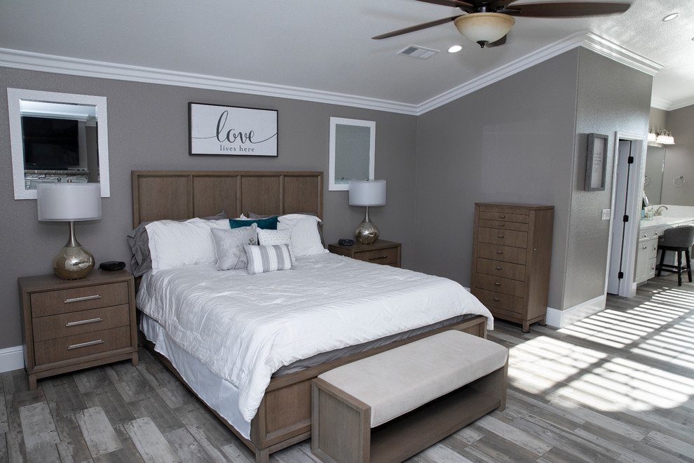 Kleines Modernes Hauptschlafzimmer mit grauer Wandfarbe, Laminat, Kamin, Kaminumrandung aus Stein und grauem Boden in Sonstige