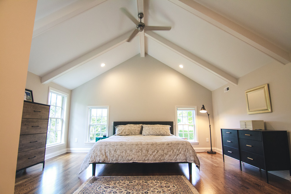 Large traditional master bedroom in Baltimore with beige walls, medium hardwood flooring, no fireplace and brown floors.