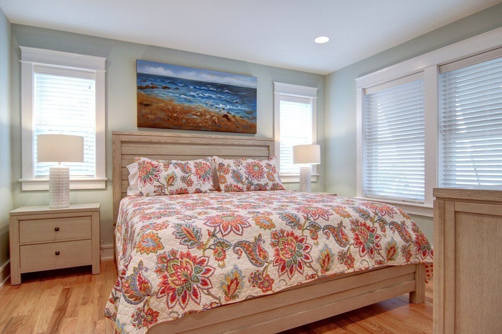 Photo of a medium sized beach style guest and grey and cream bedroom in Other with grey walls, medium hardwood flooring and no fireplace.