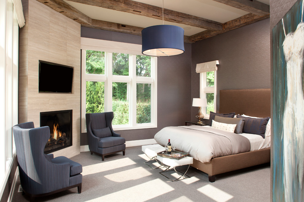 Imagen de dormitorio principal tradicional renovado con paredes azules, moqueta, chimenea de esquina y marco de chimenea de baldosas y/o azulejos