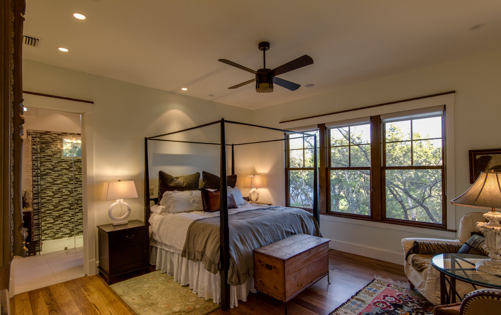 Medium sized traditional master bedroom in Austin with white walls and medium hardwood flooring.