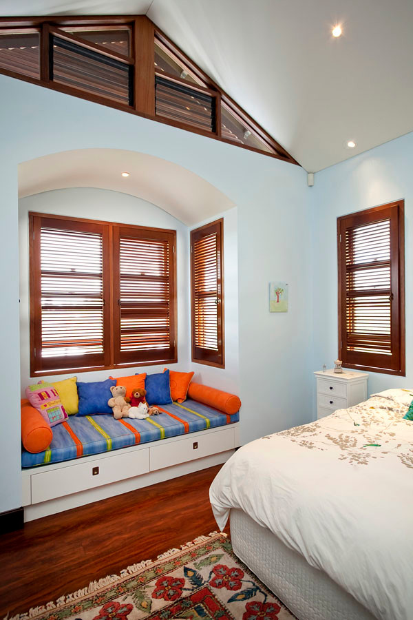 Photo of an expansive classic bedroom in Brisbane with blue walls, medium hardwood flooring, no fireplace and brown floors.