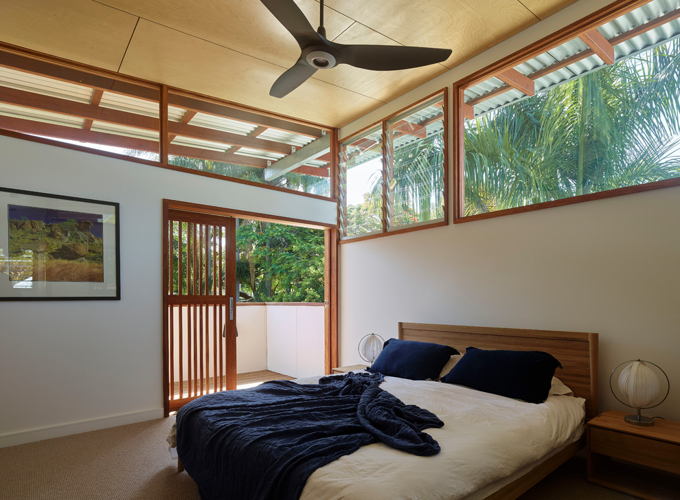 Mid-sized island style master carpeted and beige floor bedroom photo in Brisbane with white walls