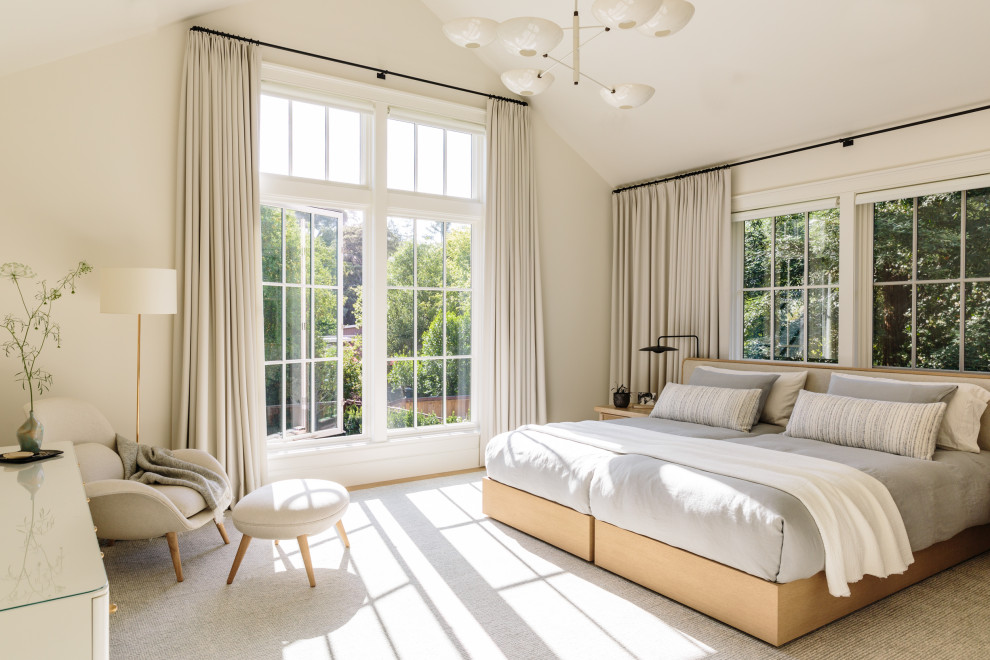 Photo of a small rural master bedroom in San Francisco with white walls, grey floors and a vaulted ceiling.