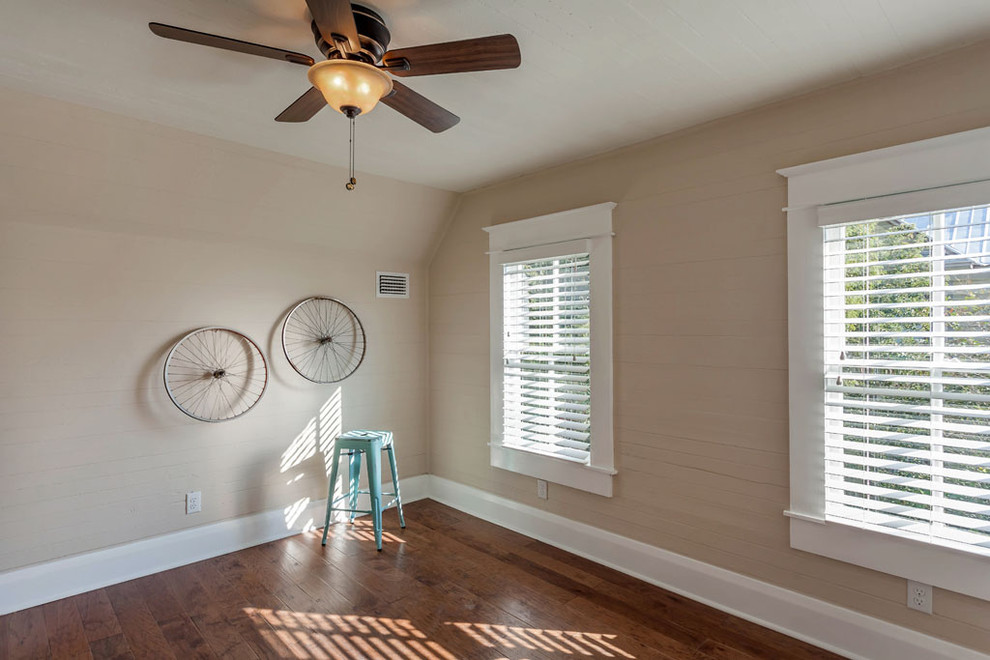 Photo of a large classic guest bedroom in Tampa with beige walls and medium hardwood flooring.