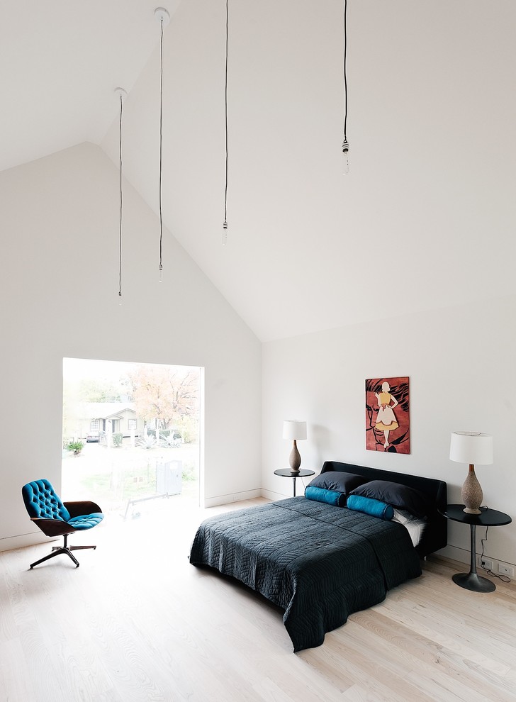 Large minimalist master light wood floor bedroom photo in Houston with white walls