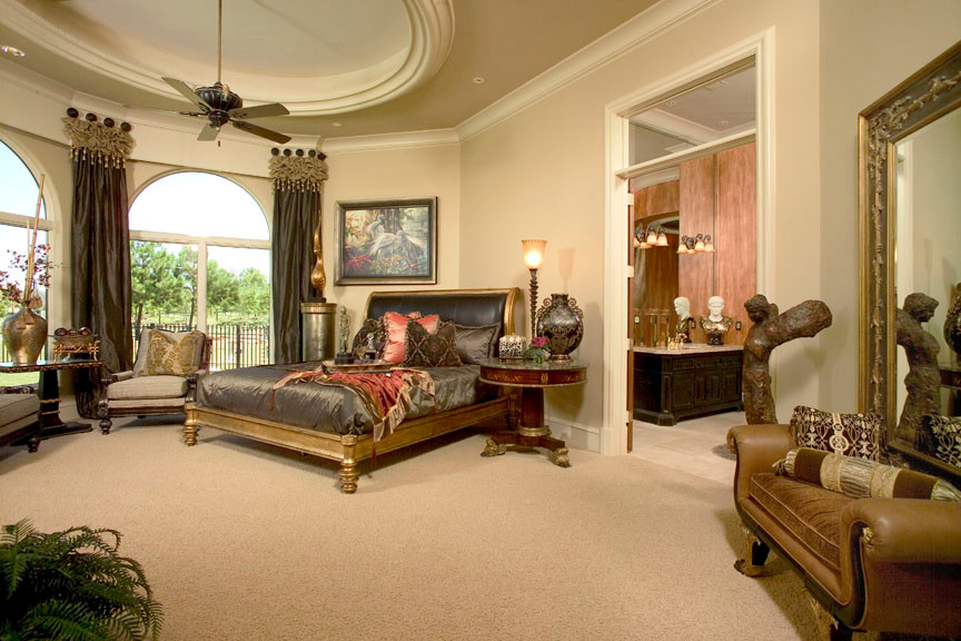 Inspiration for an expansive mediterranean master bedroom in Houston with beige walls and carpet.