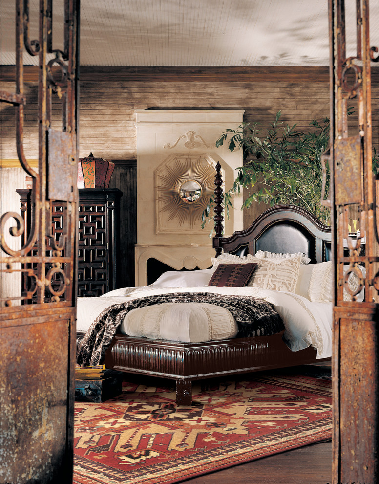 Foto de dormitorio principal tradicional de tamaño medio con paredes marrones, suelo de madera oscura, todas las chimeneas y marco de chimenea de yeso