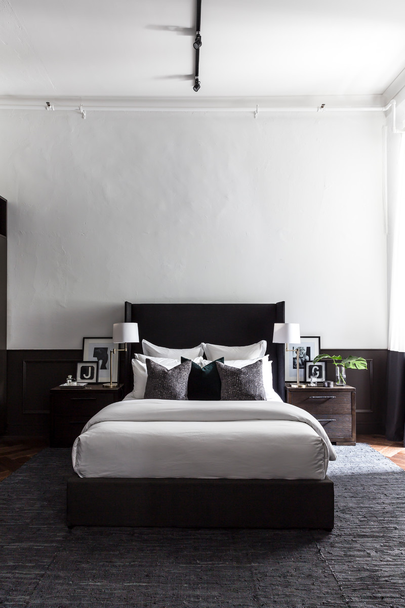 Example of a small trendy master dark wood floor and brown floor bedroom design in Sydney with white walls