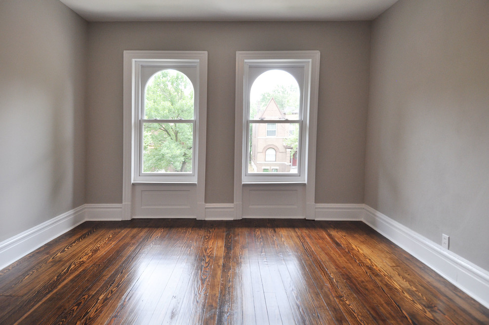 This is an example of a medium sized traditional guest bedroom in St Louis with grey walls and medium hardwood flooring.