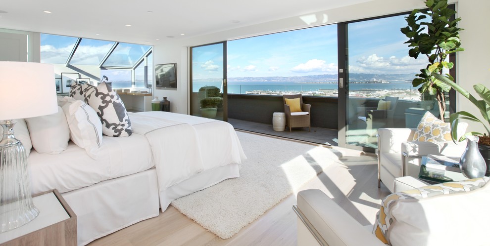 Inspiration for a large modern master light wood floor and brown floor bedroom remodel in San Francisco with white walls