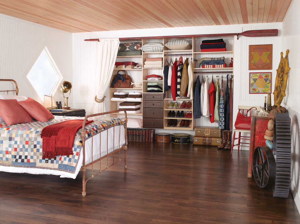 This is an example of a rustic bedroom in Raleigh with white walls, dark hardwood flooring and brown floors.