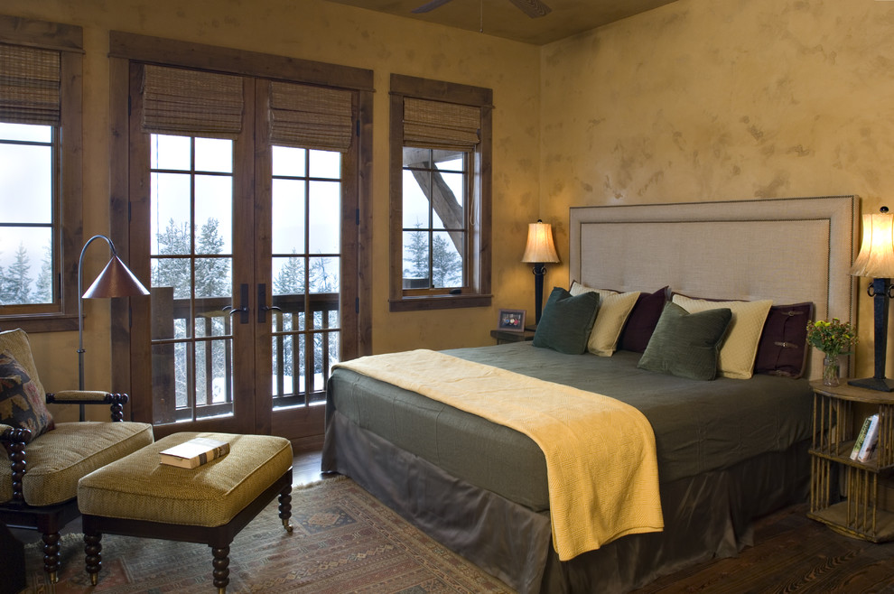 Design ideas for a rustic bedroom in Other with beige walls and dark hardwood flooring.