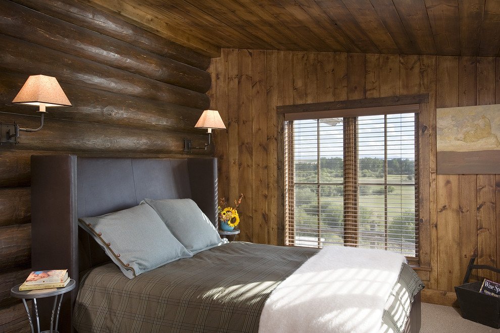 Example of a mountain style carpeted bedroom design in Other with brown walls