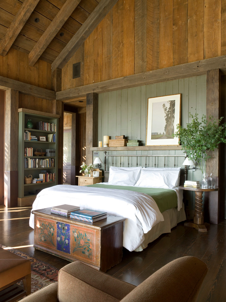 Rustic master bedroom in San Francisco with green walls and dark hardwood flooring.