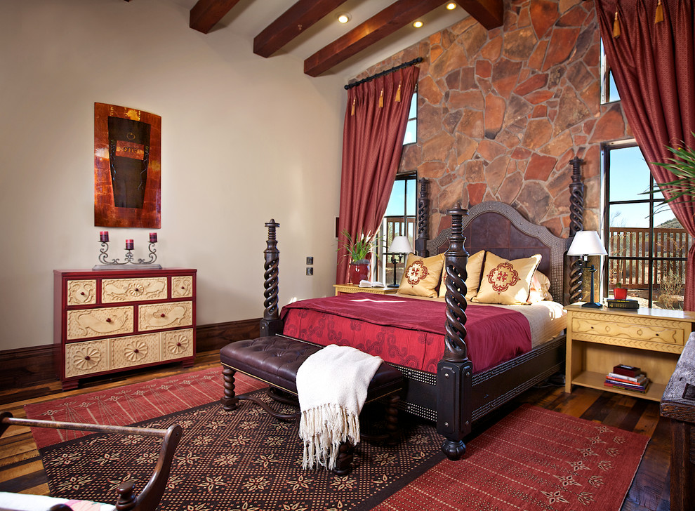 This is an example of a rustic bedroom in Phoenix with white walls and dark hardwood flooring.