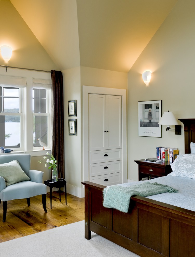 Inspiration for a rustic medium tone wood floor bedroom remodel in Burlington with beige walls