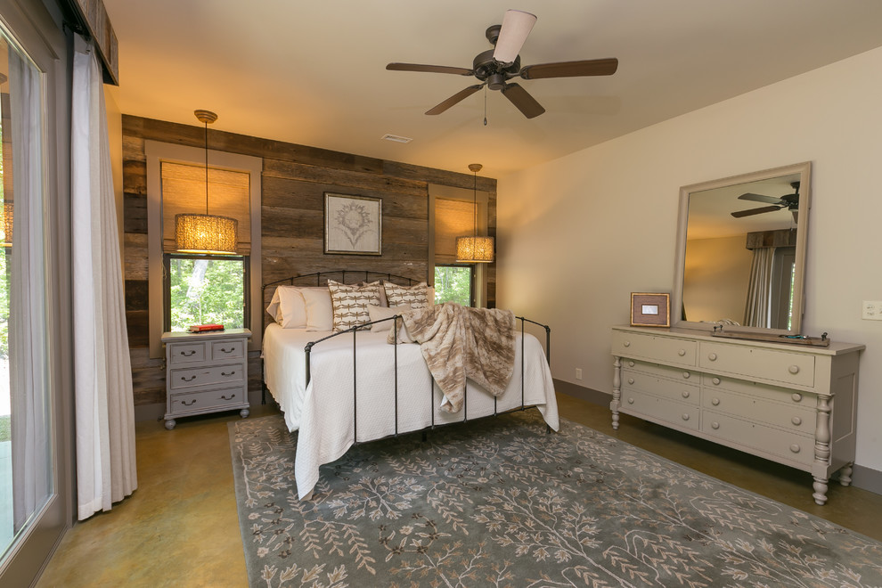 Imagen de dormitorio principal rural con paredes beige y suelo de cemento