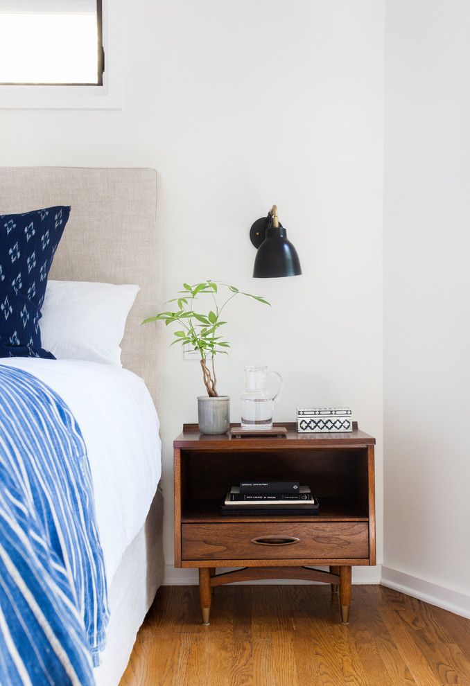 Eclectic master bedroom in Los Angeles with white walls.