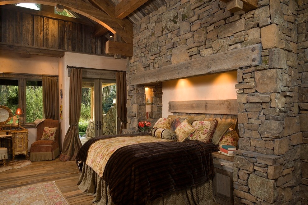 Uriges Hauptschlafzimmer mit beiger Wandfarbe und braunem Holzboden in Sonstige