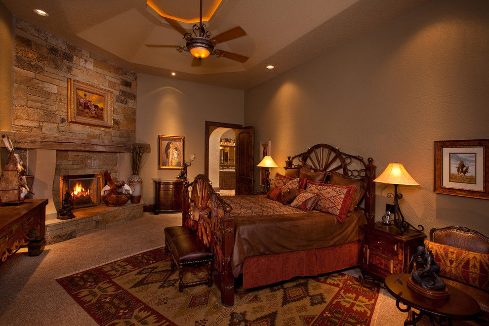 Inspiration for a large rustic master carpeted bedroom remodel in Dallas with beige walls, a corner fireplace and a wood fireplace surround
