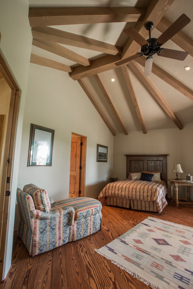Example of a mid-sized mountain style master dark wood floor and brown floor bedroom design in Santa Barbara with beige walls and no fireplace