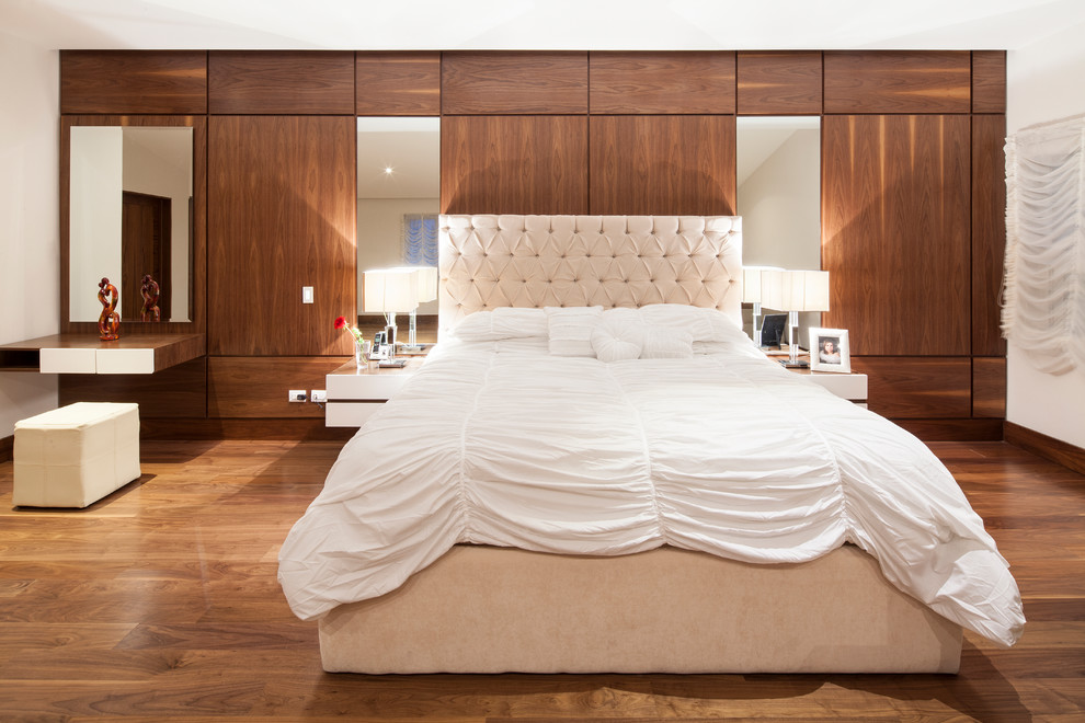 Bedroom - contemporary master medium tone wood floor bedroom idea in Other with beige walls