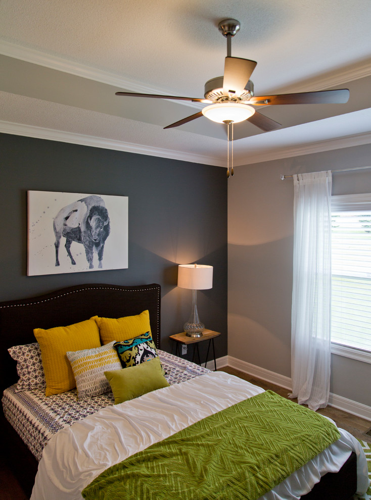 Aménagement d'une grande chambre parentale éclectique avec un mur gris, un sol en bois brun et un sol marron.