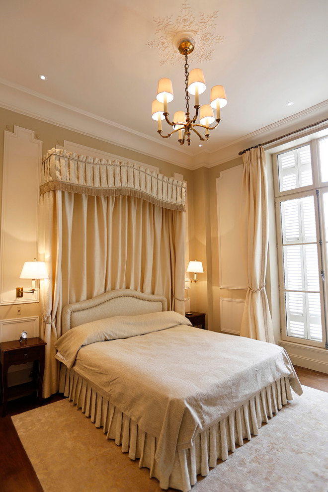 Large transitional master bedroom photo in London with beige walls