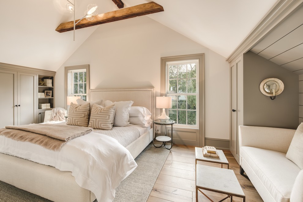 This is an example of a rural grey and brown bedroom in New York with white walls, medium hardwood flooring and brown floors.