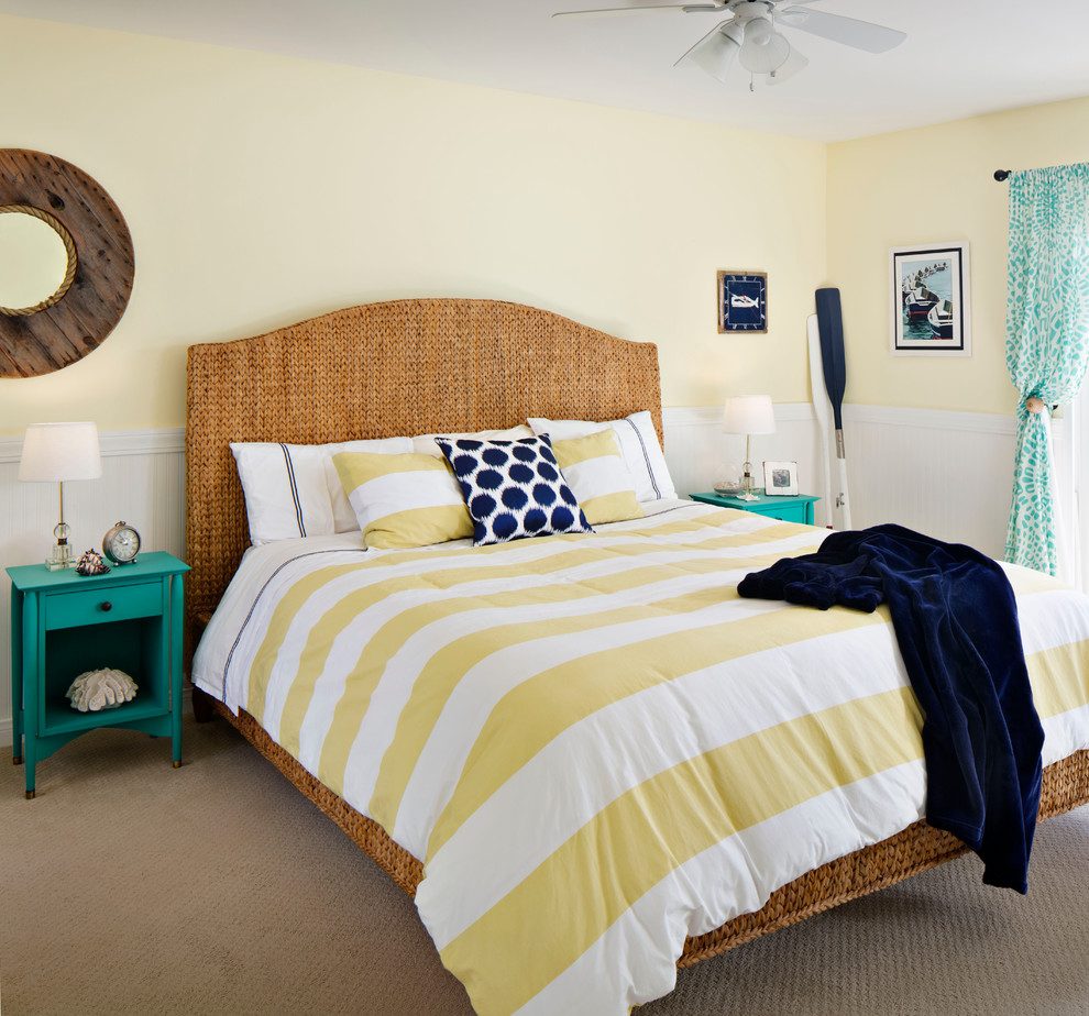 This is an example of a medium sized beach style master bedroom in San Francisco with yellow walls, carpet and no fireplace.