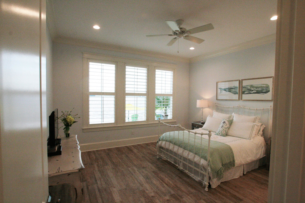 Inspiration for a large coastal guest dark wood floor bedroom remodel with gray walls and no fireplace